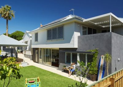 Exterior of family beach home with Breezway Louvres