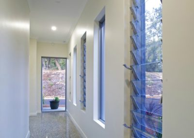 Hallway using tall narrow Breezway Louvres to ventilate the area
