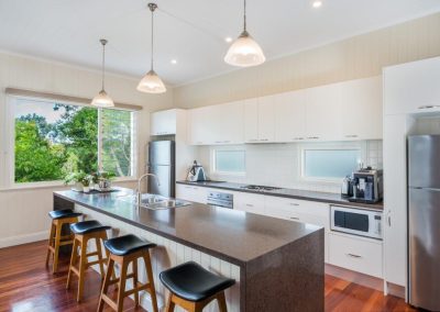 Louvres in the kitchen next to fixed lite allows views to be maintained while airflow can be controlled