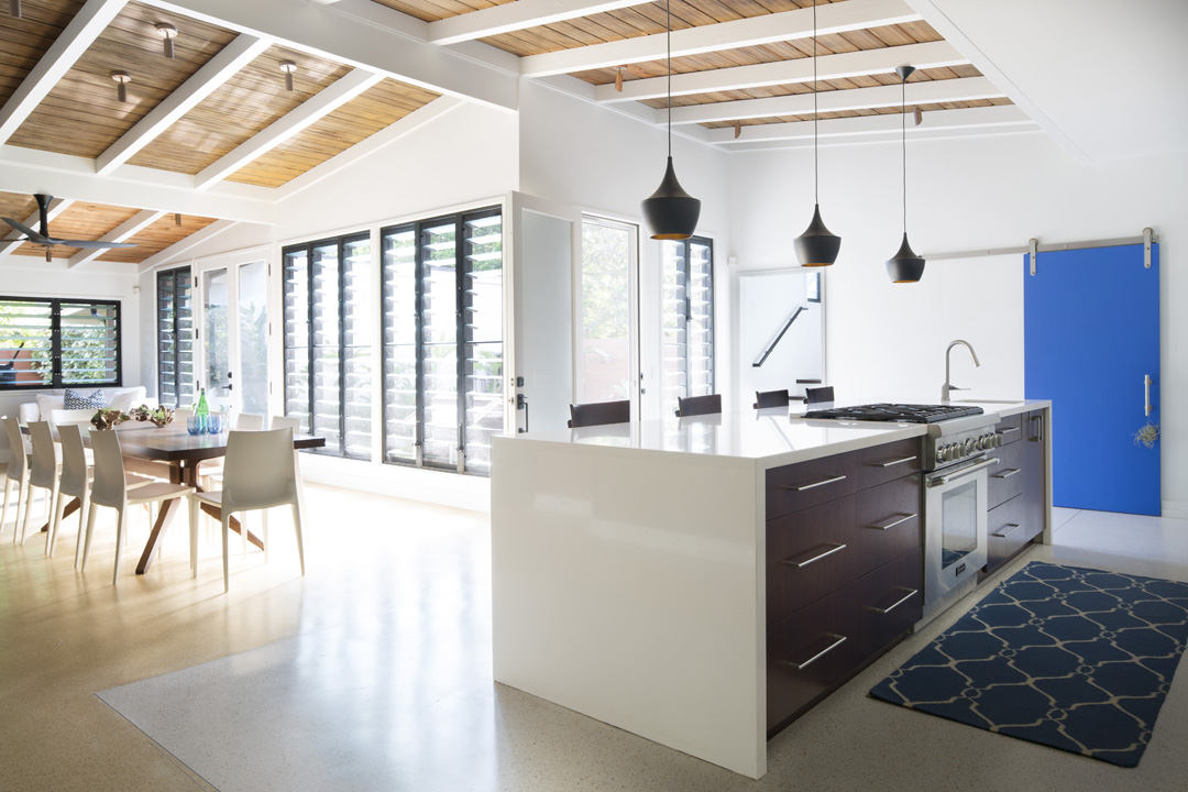 Open plan kitchen and dining varea with multiple banks of breezway louvres