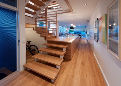 Staircase and view out onto courtyard with Breezway louvres in distance