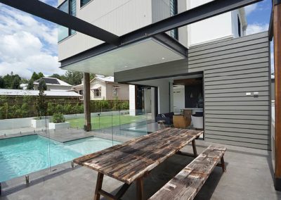 View out onto outdoor area and pool with louvres up high on second level