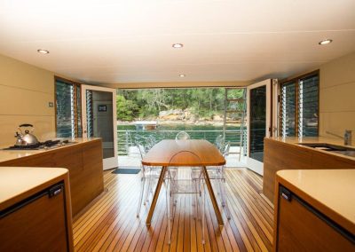 Kitchen and dining area with floor to ceiling Breezway louvre windows