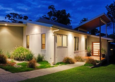 Exterior of home at night with Breezway Louvres