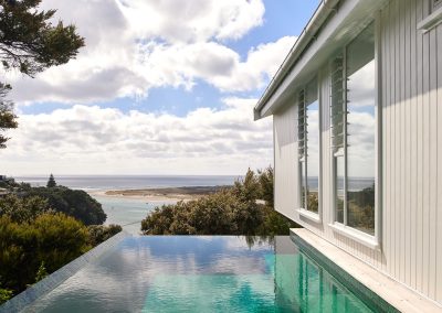 DAA Mangawhai home featuring breezway louvres overlooking pool