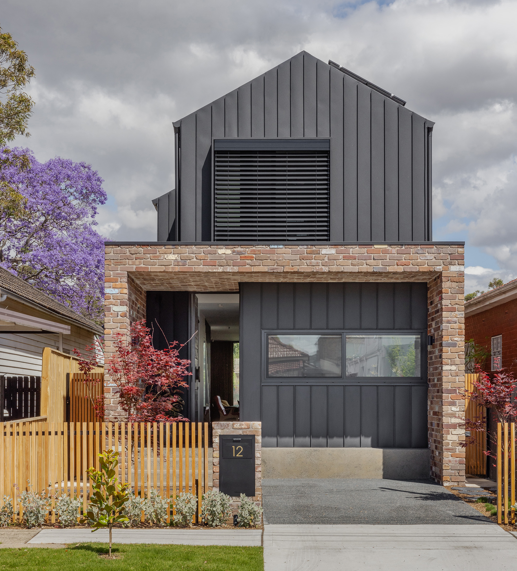 Front Facade of Twelve Black Residential Home DAA Mangawhai home featuring breezway louvres overlooking pool