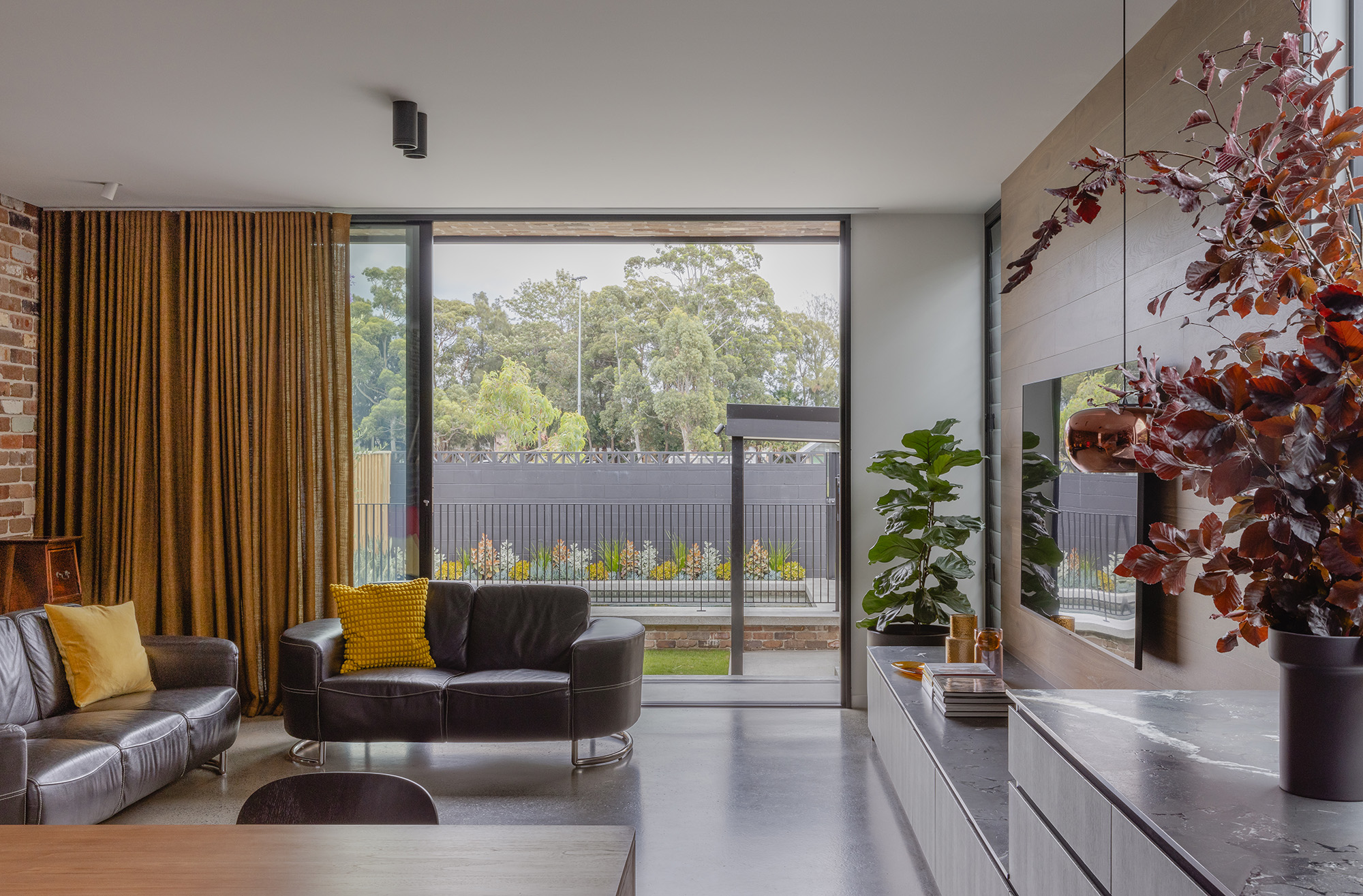 Living Room inside Twelve Black Residence DAA Mangawhai bathroom featuring breezway louvres for ventilation