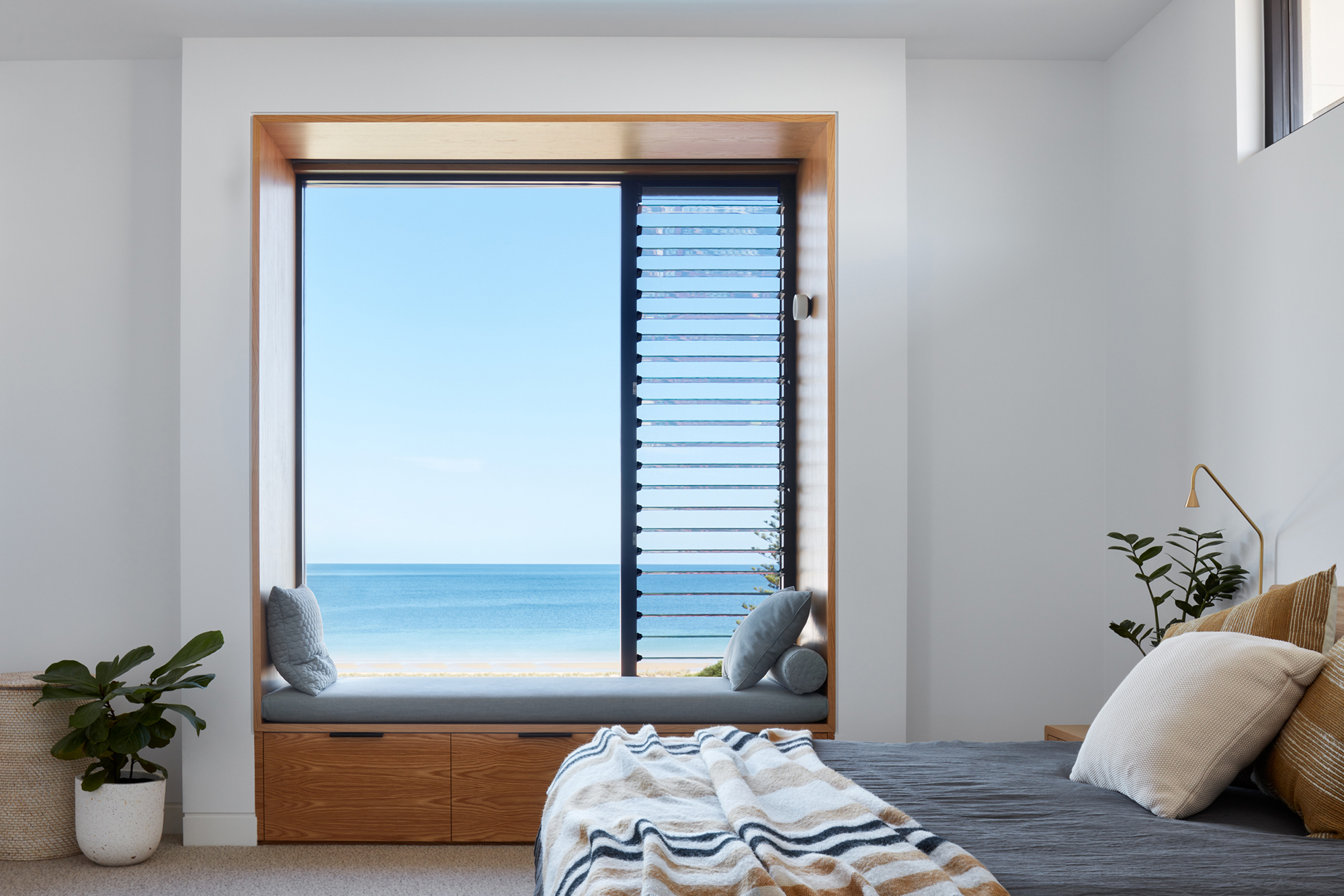 Breezway Louvres next to fixed lite glazing help frame a view while providing ventilation DAA Mangawhai bathroom featuring breezway louvres for ventilation
